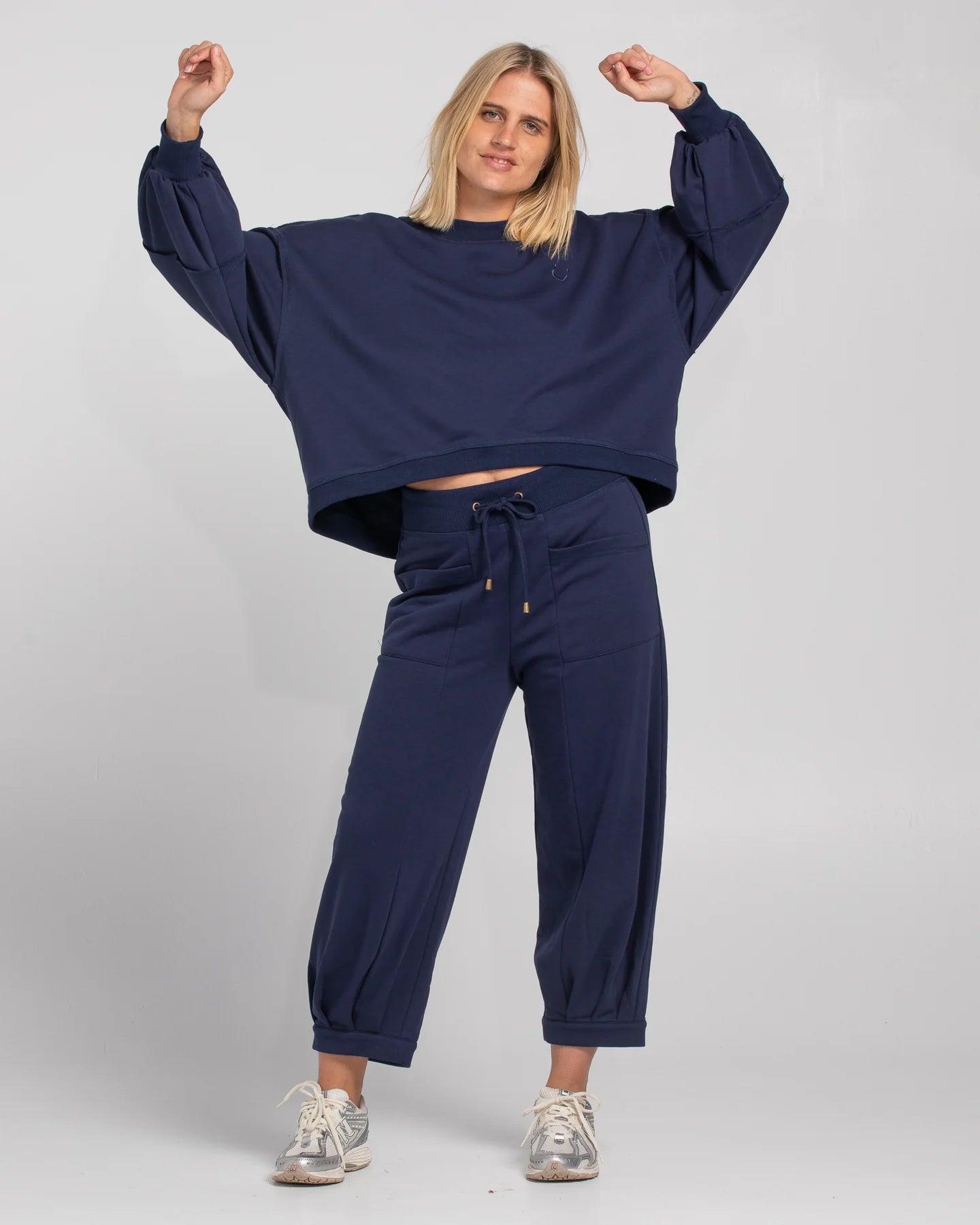 Oversized cropped Guru Sweater with balloon sleeves, contrast stitching, raw seam details, and ribbed neckline, cuffs, and hem with SMILE logo