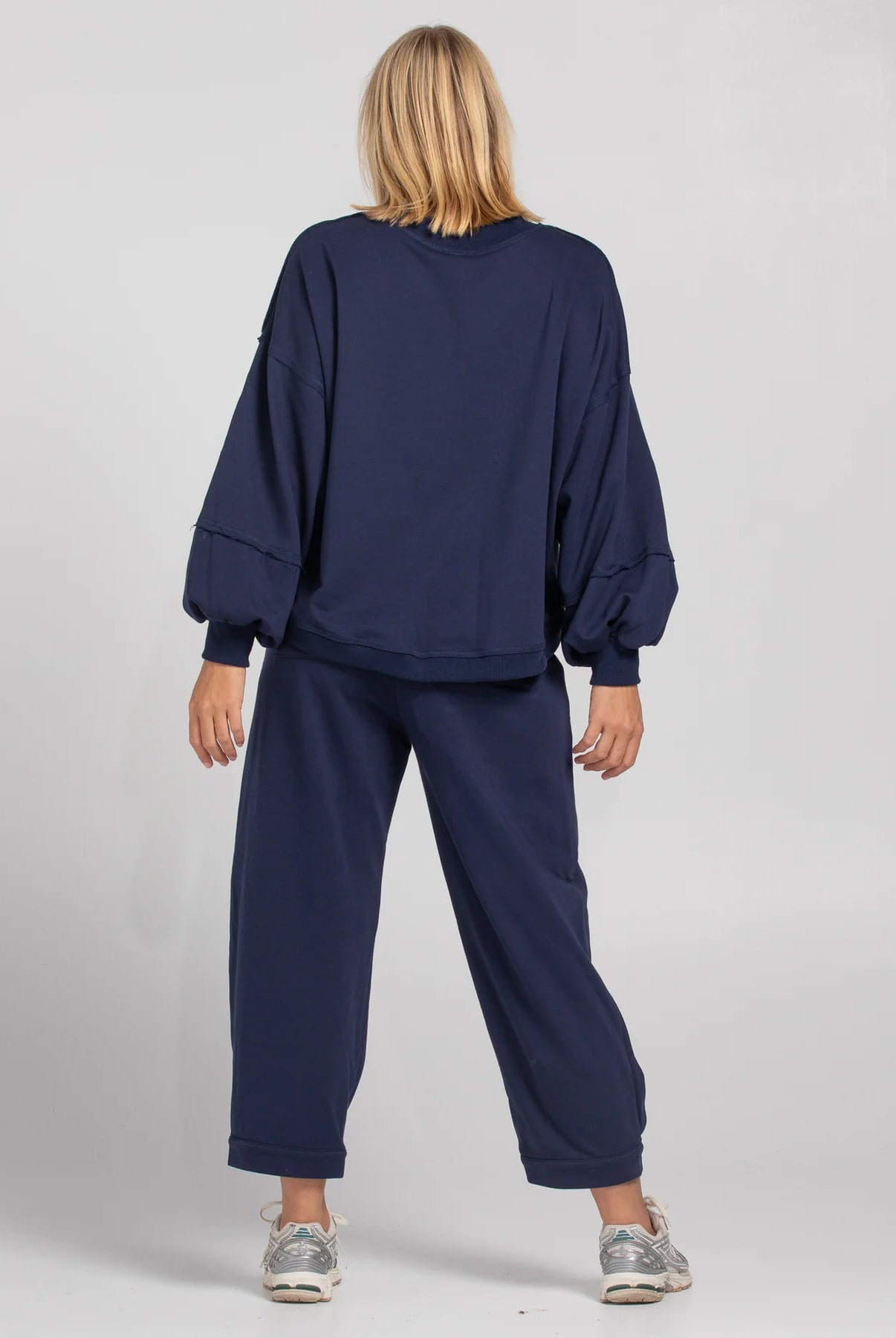 Boom Shankar Guru Track Pants in a relaxed fit with drawstring waistband, pleated front, contrast stitching, and back pocket SMILE logo
