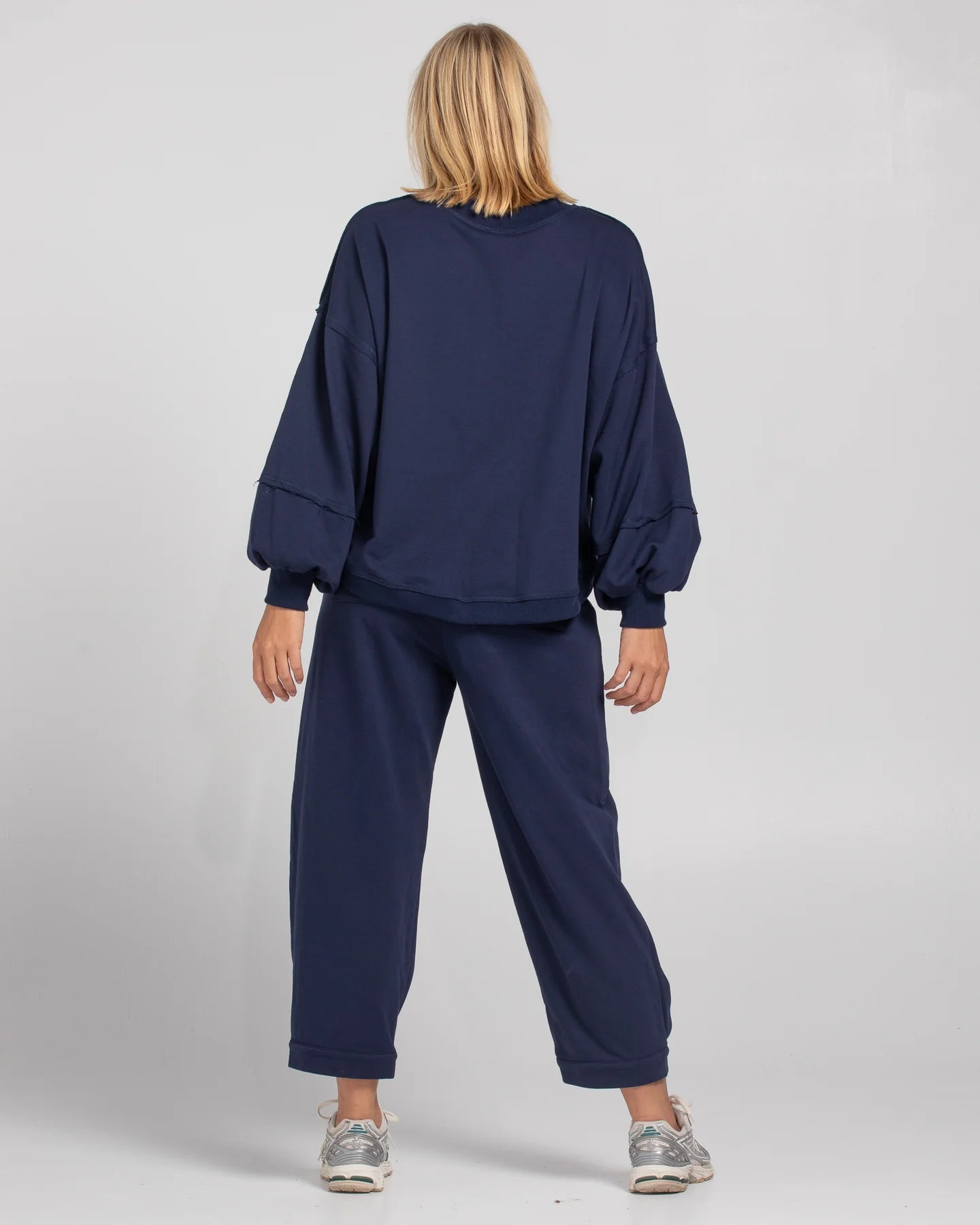 Boom Shankar Guru Track Pants in a relaxed fit with drawstring waistband, pleated front, contrast stitching, and back pocket SMILE logo
