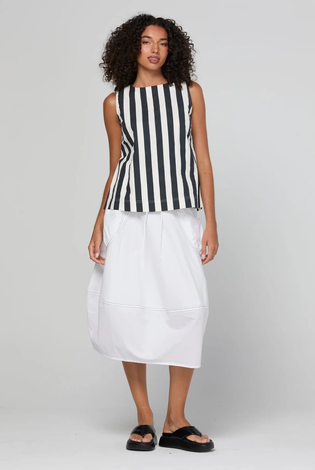 Guru Skirt in Coconut featuring a 3/4 length, stretch drawstring waistband, front and back pockets, full lining and black contrast stitching.