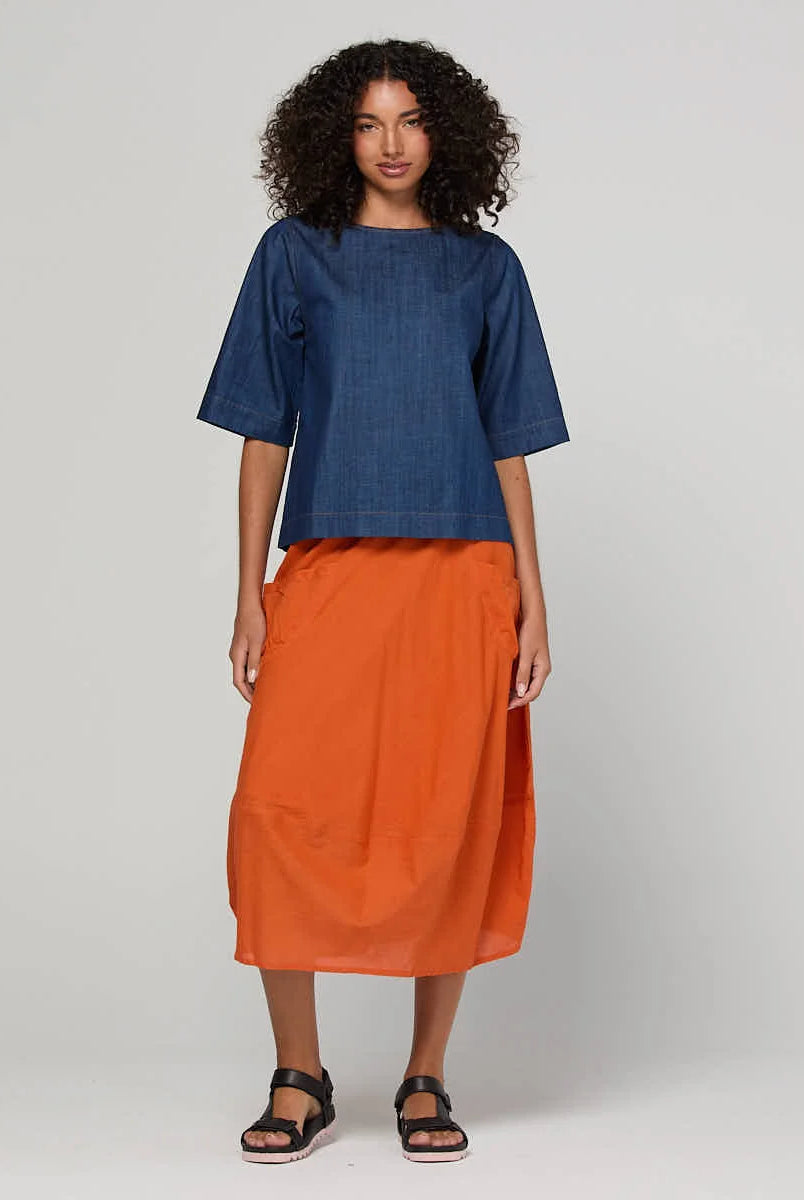 Guru Skirt in Rust, featuring a 3/4 length, stretch drawstring waistband, front and back pockets, full lining and black contrast stitching.