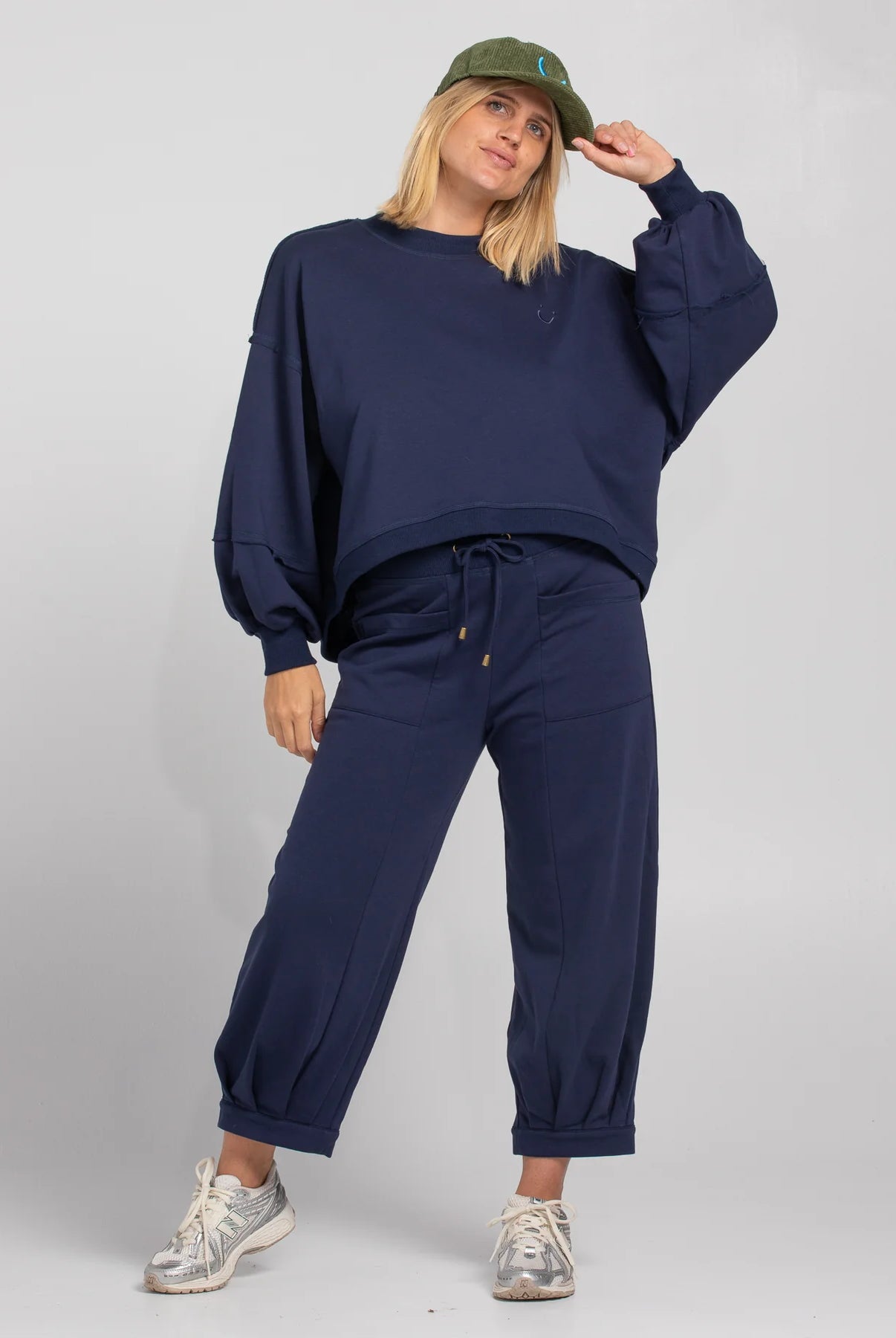 Oversized cropped Guru Sweater with balloon sleeves, contrast stitching, raw seam details, and ribbed neckline, cuffs, and hem with SMILE logo