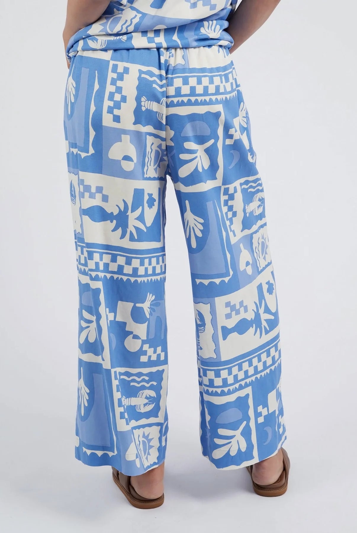 Add a pop of style to your wardrobe with the Postcard Print Holiday Sun Pants.