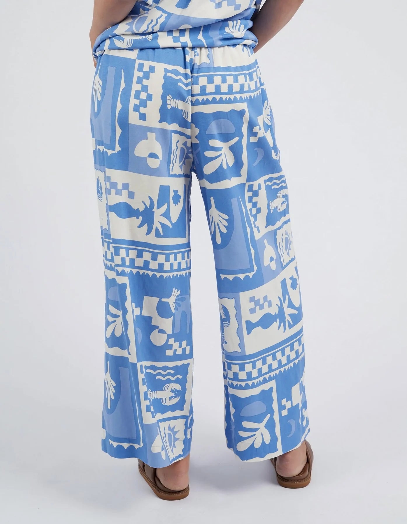 Add a pop of style to your wardrobe with the Postcard Print Holiday Sun Pants.