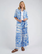 Add a pop of style to your wardrobe with the Postcard Print Holiday Sun Pants.