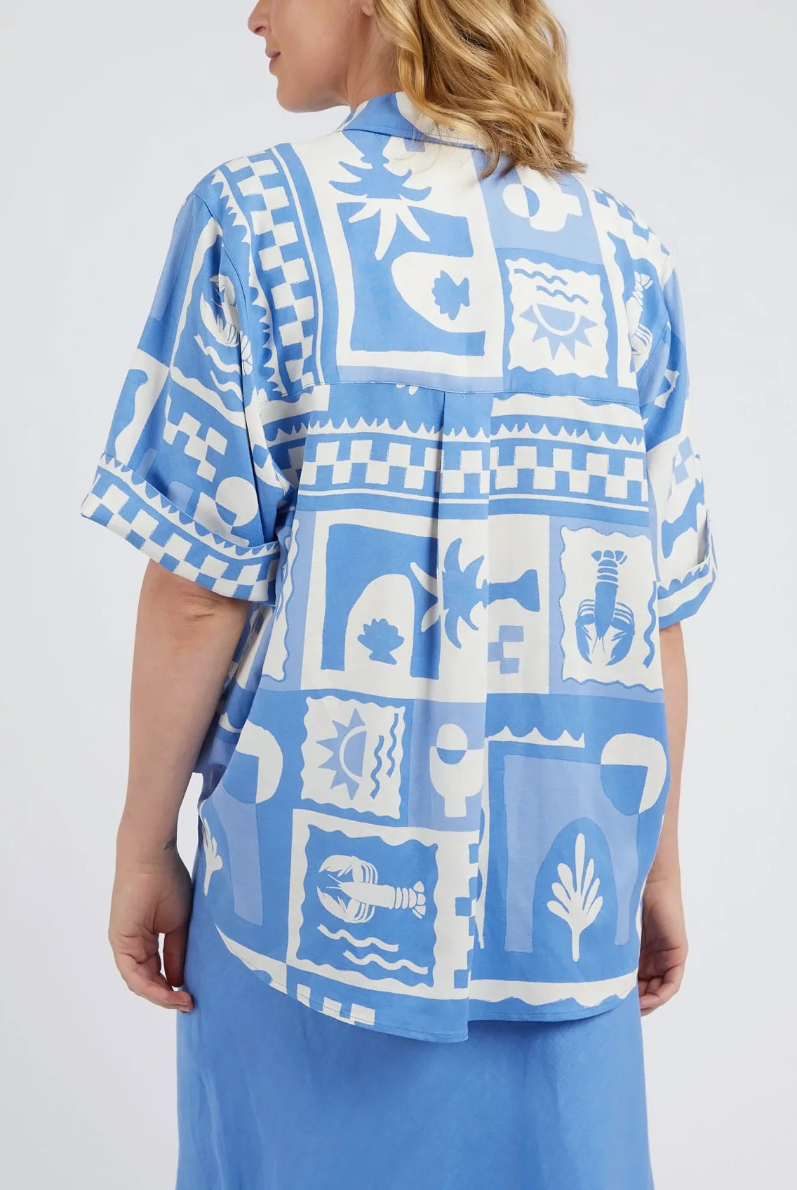 A woman modelling the Holiday Sun Shirt With Prints in Cerulean Holiday Design by Elm from behind