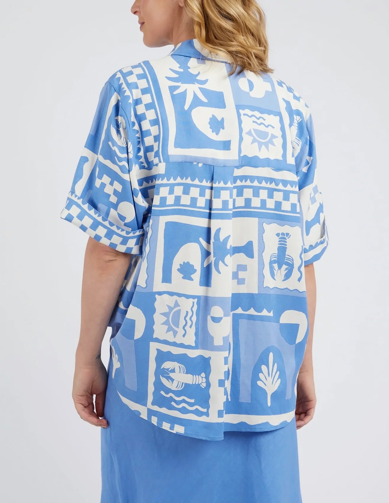 A woman modelling the Holiday Sun Shirt With Prints in Cerulean Holiday Design by Elm from behind