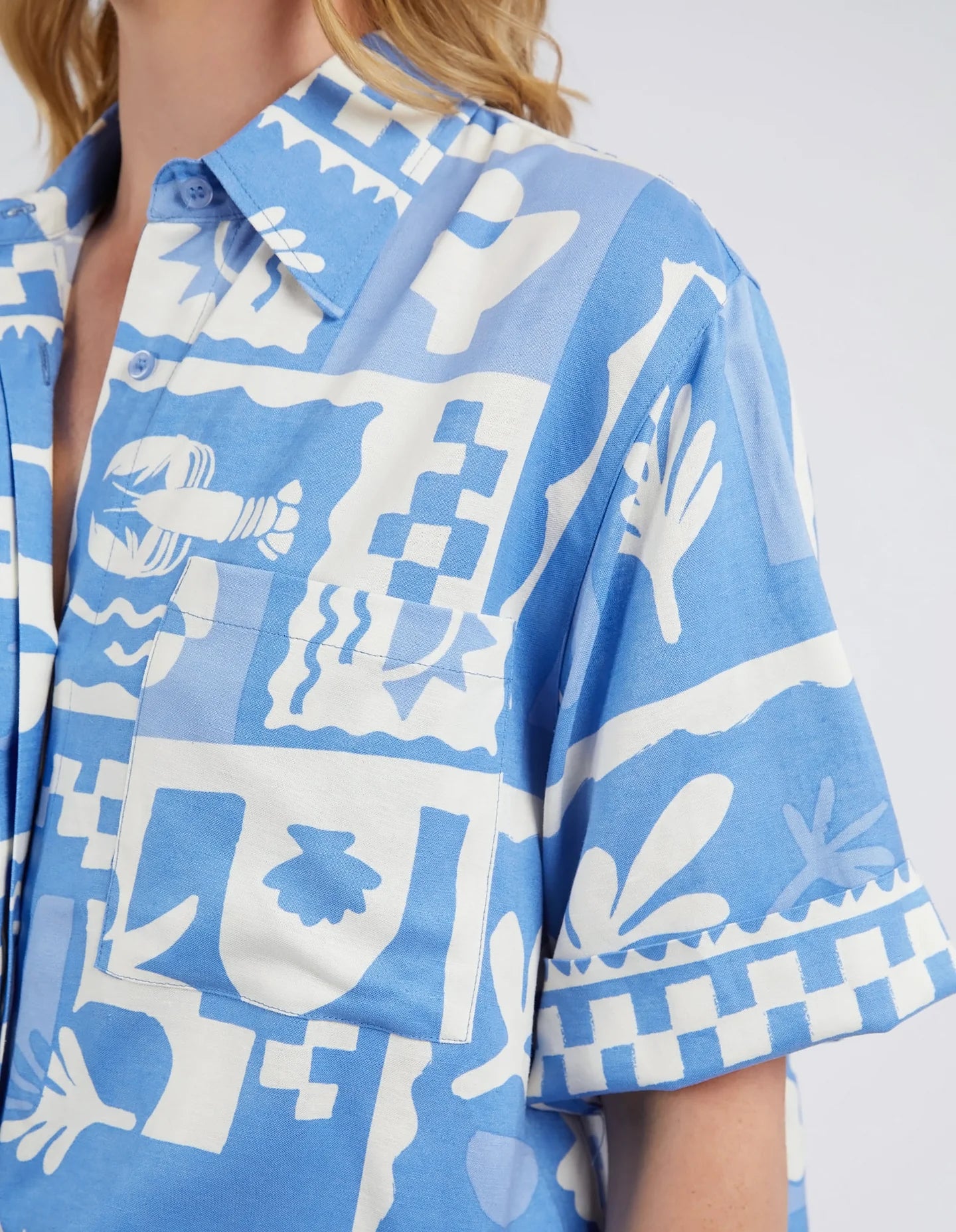 A woman close up modelling the Holiday Sun Shirt With Prints in Cerulean Holiday Design by Elm