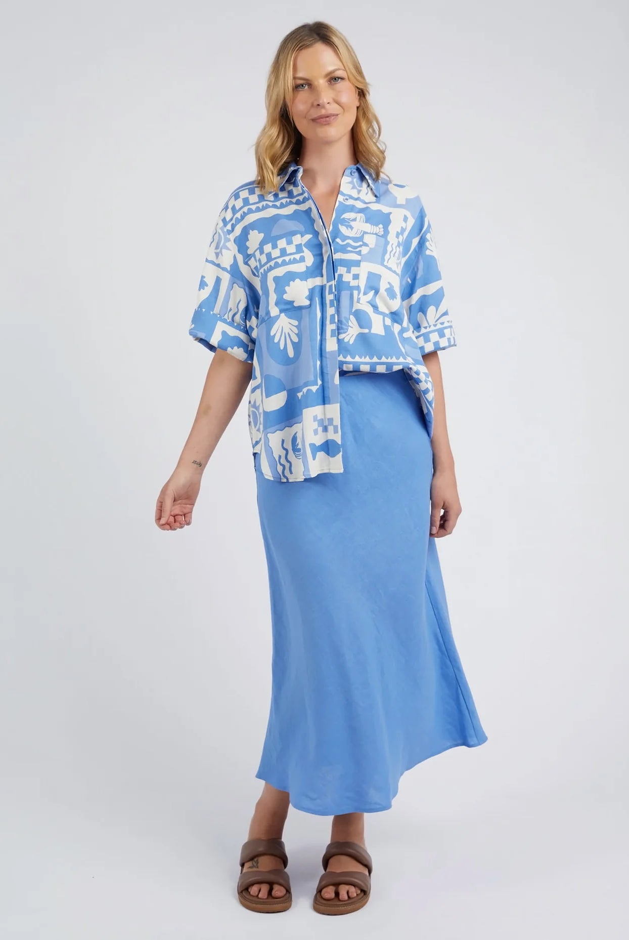 A woman modelling the Holiday Sun Shirt With Prints in Cerulean Holiday Design by Elm