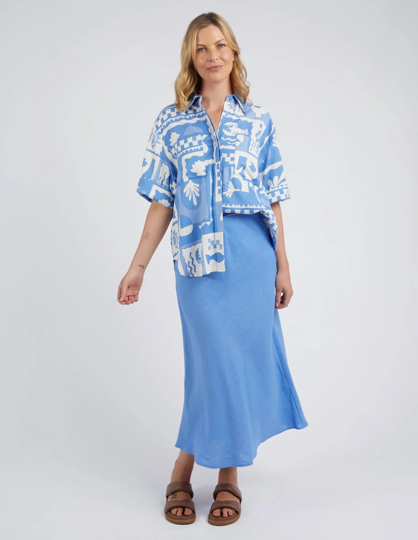 A woman modelling the Holiday Sun Shirt With Prints in Cerulean Holiday Design by Elm