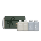 al.ive body Holiday Travel Pack featuring Sea Cotton & Coconut Wash and Lotion and White Tea & Argan Shampoo and Conditioner in a premium Stone and Steel Blue travel bag.