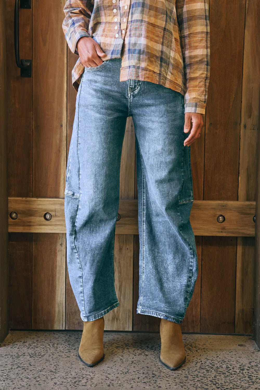 Mid-blue denim barrel-leg jeans with a relaxed fit, cuffed hem, side panel detailing, contrast stitching, and 5-pocket design.