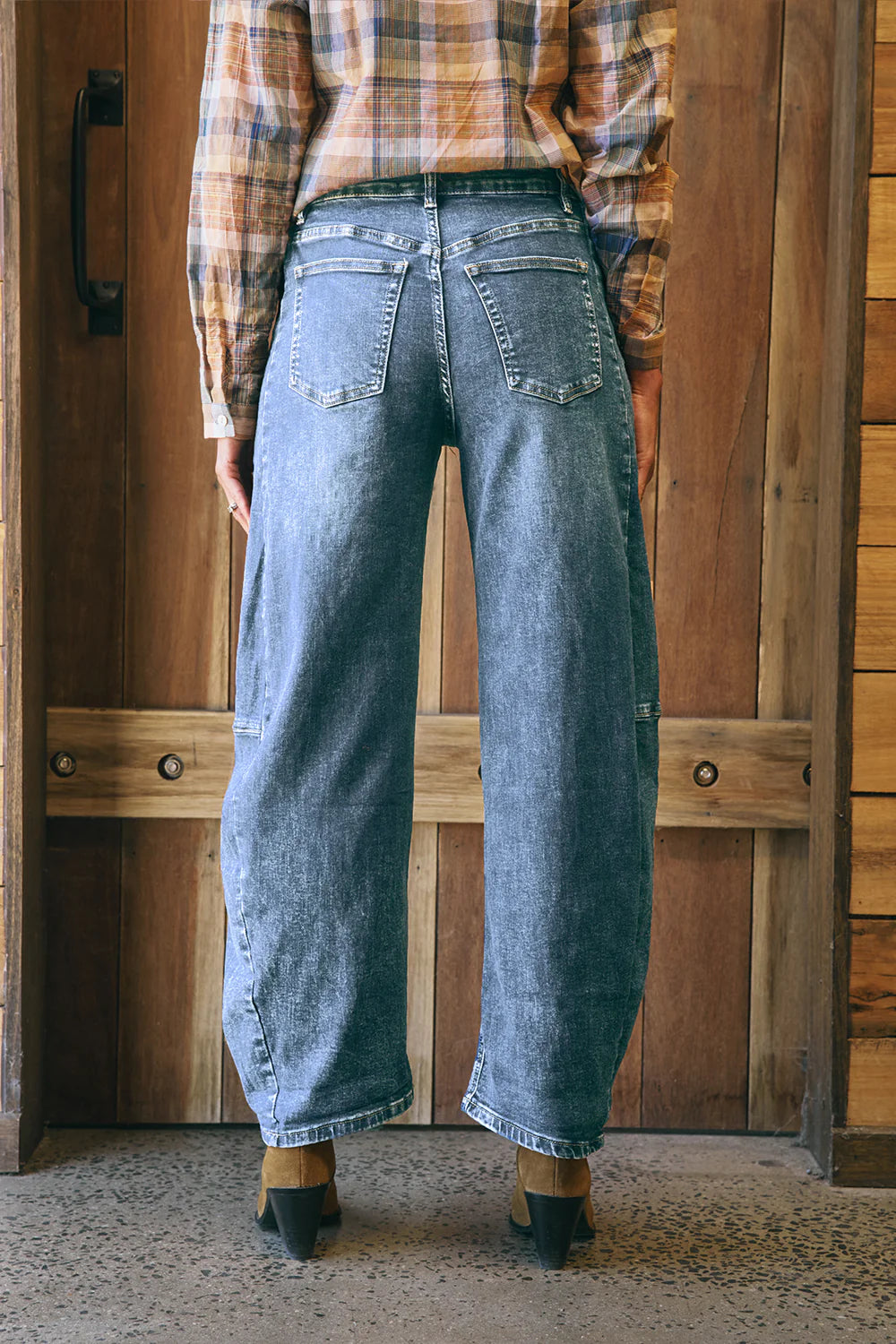 Mid-blue denim barrel-leg jeans with a relaxed fit, cuffed hem, side panel detailing, contrast stitching, and 5-pocket design.