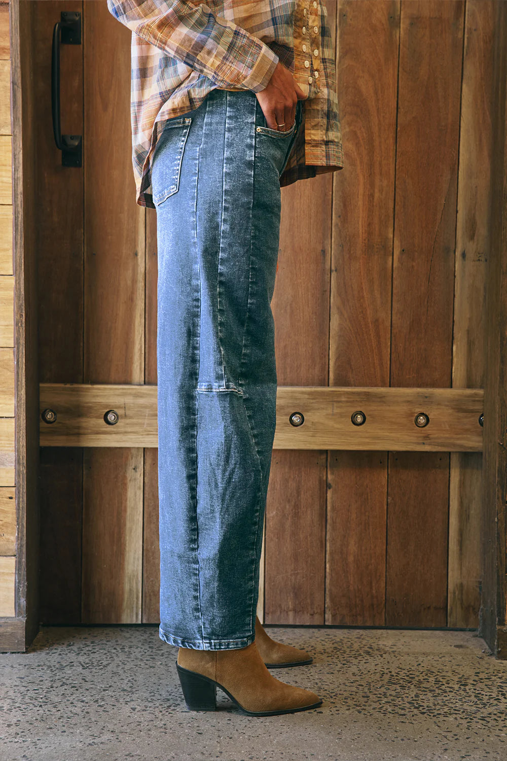 Mid-blue denim barrel-leg jeans with a relaxed fit, cuffed hem, side panel detailing, contrast stitching, and 5-pocket design.