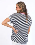 Navy and white striped Jarrah Short Sleeve Tee by Elm with a pink contrast neckline, relaxed fit, cuffed sleeves, and side splits.