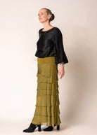 The Karley Satin Finish Top in Onyx features long sleeves with bell cuffs, a round neckline, and a split hemline, offering a sleek and modern silhouette.