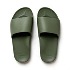 A pair of khaki-colored arch support slides with a contoured footbed designed for comfort. The slides feature a wide, cushioned strap and a thick sole for enhanced support and stability.