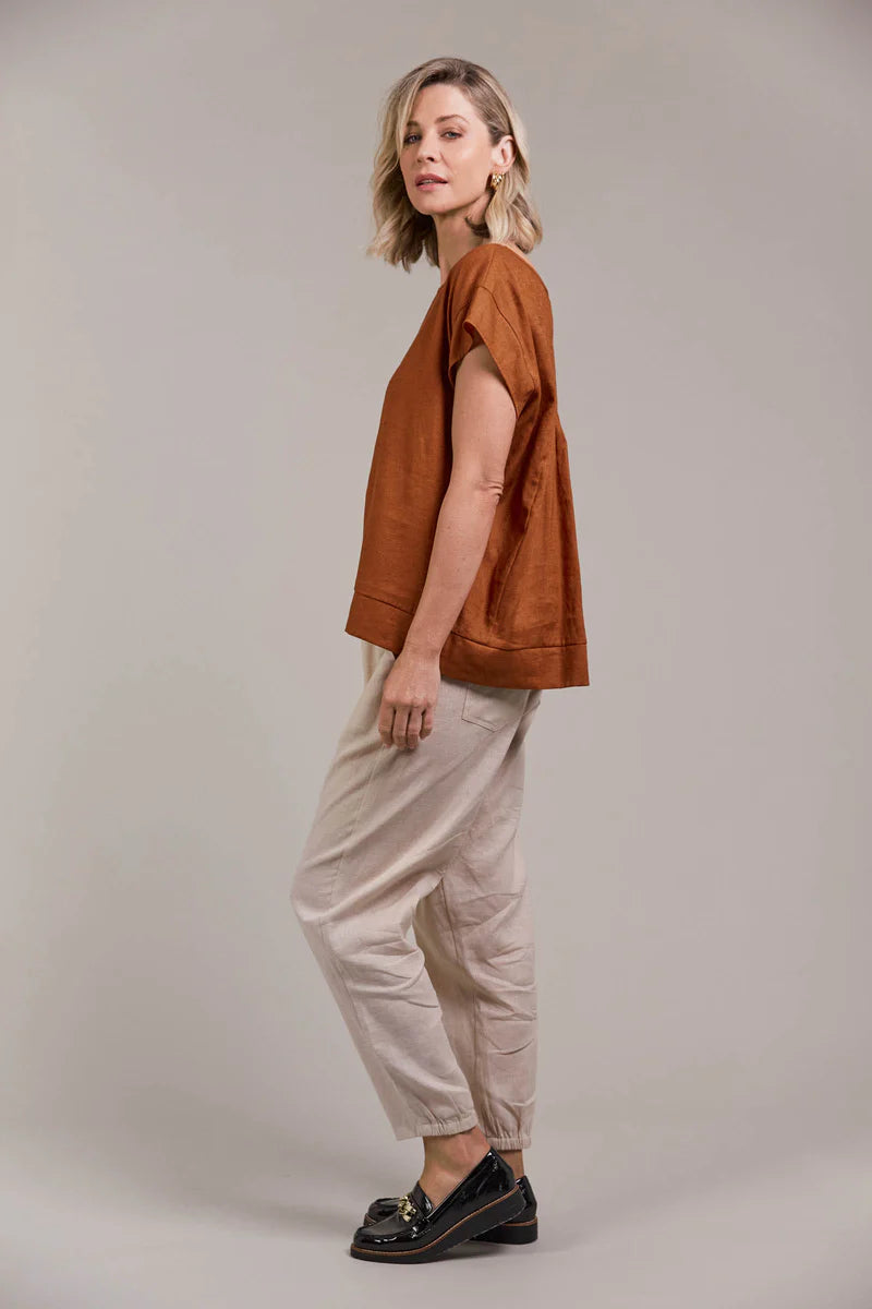A hazel-colored top made from a linen-cotton blend, featuring a round neckline, short sleeves, high-low hem, and a gathered detail at the back for an effortlessly chic look.