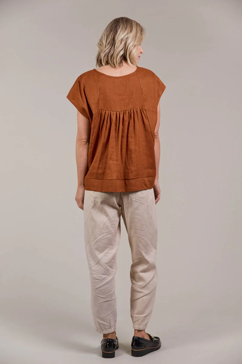 A hazel-colored top made from a linen-cotton blend, featuring a round neckline, short sleeves, high-low hem, and a gathered detail at the back for an effortlessly chic look.