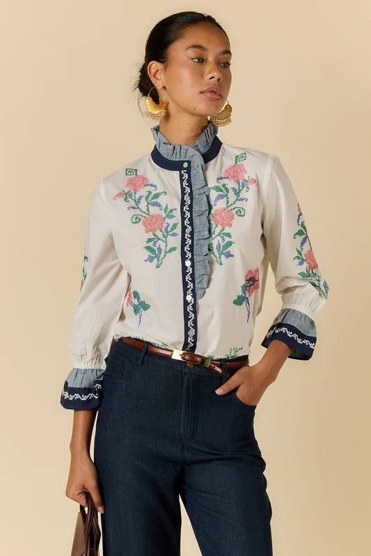 Rubyaya Lara Frill Top in cream featuring floral embroidery, contrast trim and a ruffle neckline.