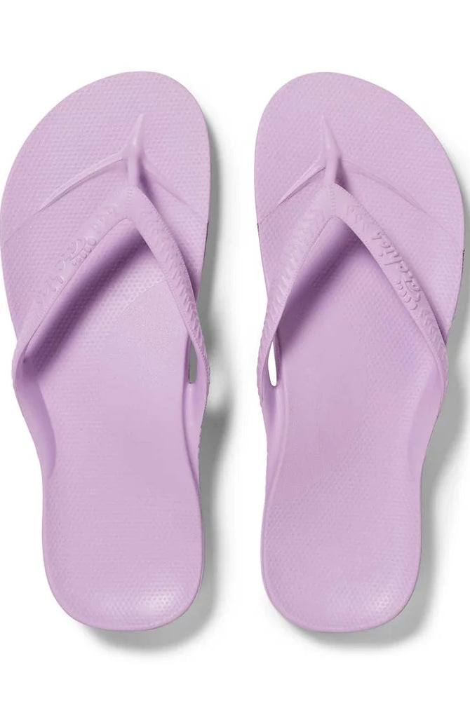 Lilac arch support thongs with contoured footbeds and ergonomic straps for enhanced comfort and stability.