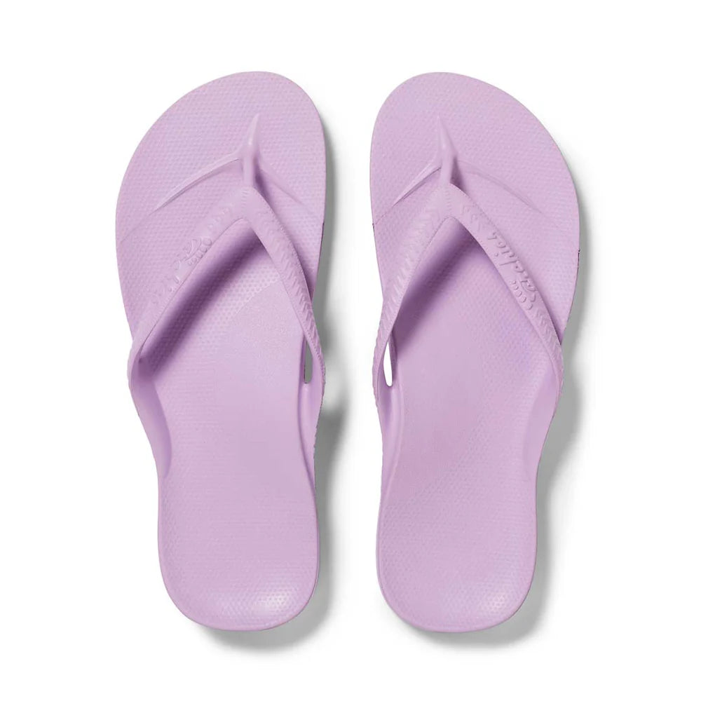 Lilac arch support thongs with contoured footbeds and ergonomic straps for enhanced comfort and stability.