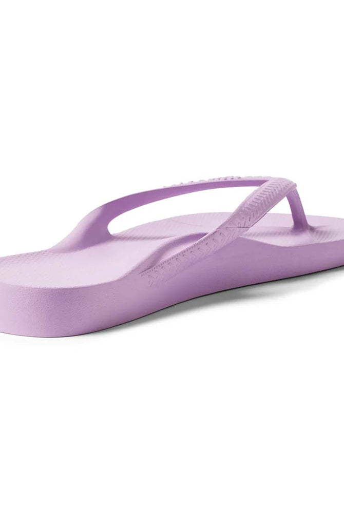 Lilac arch support thongs with contoured footbeds and ergonomic straps for enhanced comfort and stability.