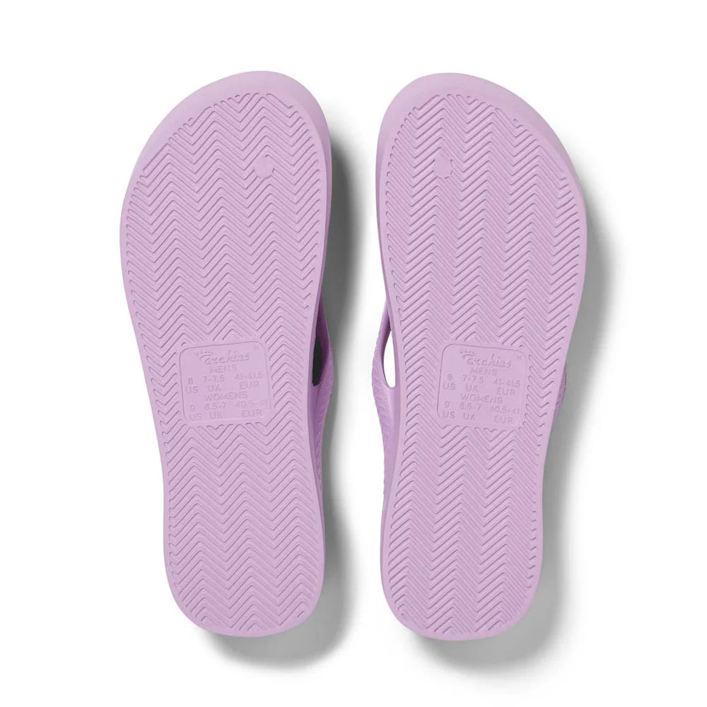 Lilac arch support thongs with contoured footbeds and ergonomic straps for enhanced comfort and stability.