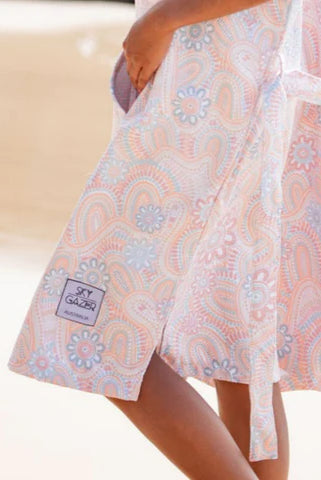 The Malua Surf Poncho is a sand-free, super-absorbent, quick-drying hooded towel. Lightweight, antibacterial, and soft, with a pocket and optional waist tie.