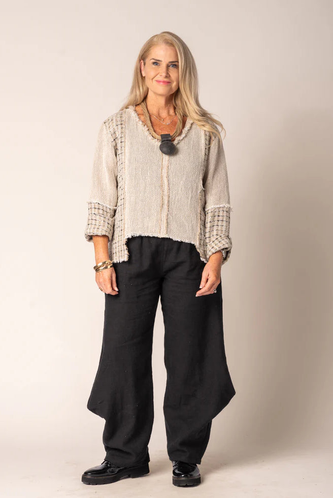 Marisol Top in Latte featuring a cropped V-neck design, asymmetrical hemline, and fringed detailing.