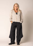 Marisol Top in Latte featuring a cropped V-neck design, asymmetrical hemline, and fringed detailing.