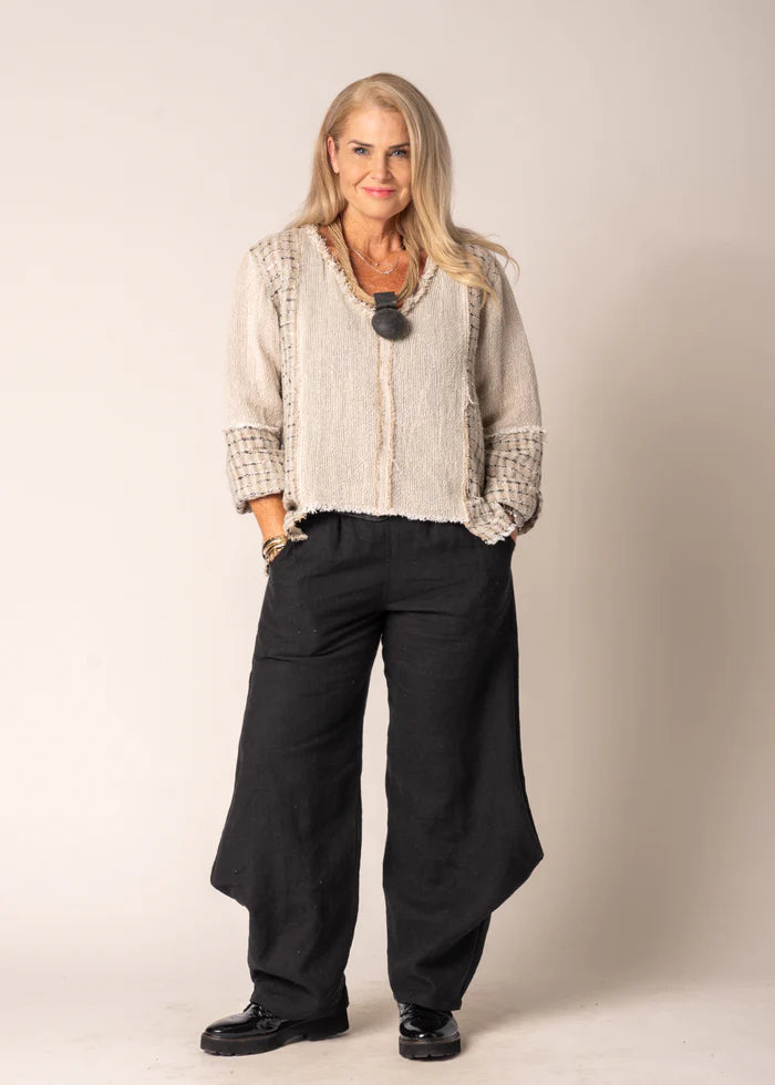 Marisol Top in Latte featuring a cropped V-neck design, asymmetrical hemline, and fringed detailing.