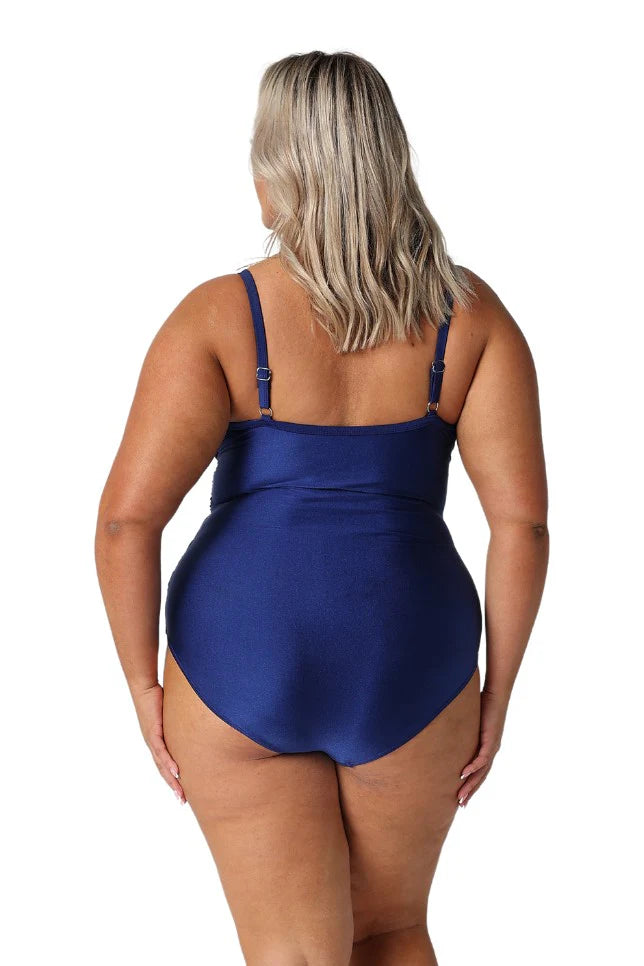 A woman modelling plus size swim wear in the Metallic Navy Criss Cross One Piece
