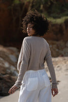 Miri Cashmere Sweater in oatmeal, lightweight and soft, with a cozy, minimalist look.