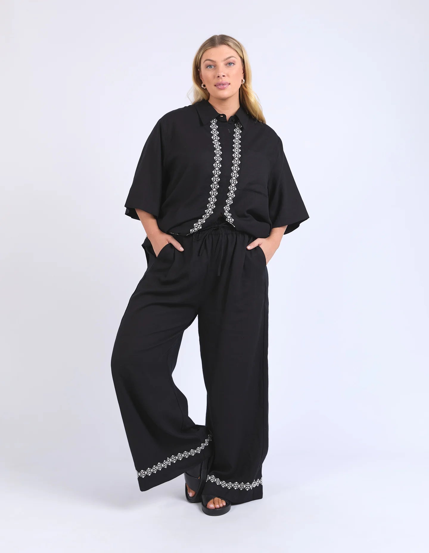 Black linen-viscose pants with an elastic waistband and embroidered hem, offering a relaxed and stylish fit.