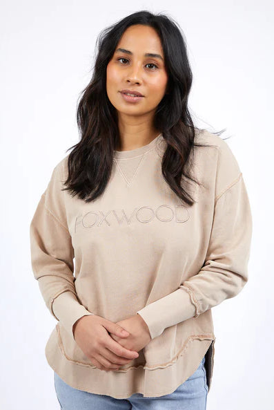 Foxwood Simplified Crew in oatmeal with round neck, raw edge details, and side splits for a relaxed, everyday look.