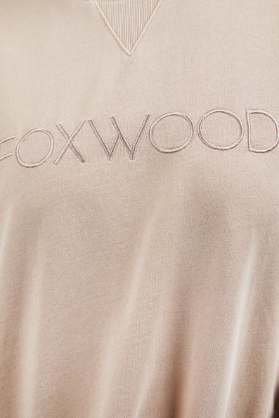Foxwood Simplified Crew in oatmeal with round neck, raw edge details, and side splits for a relaxed, everyday look.