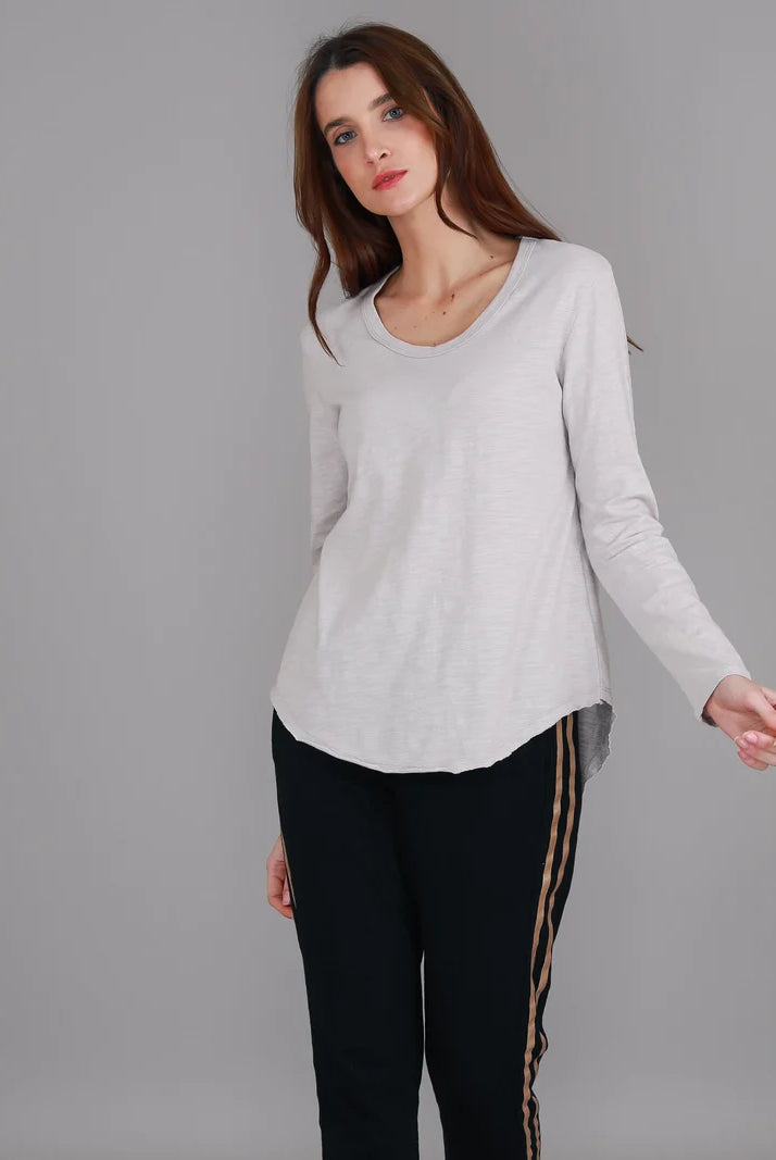 Angora Penola Long Sleeve T-Shirt featuring a crew neckline, relaxed full-length sleeves, straight silhouette and curved raw-edge hi-lo hem.