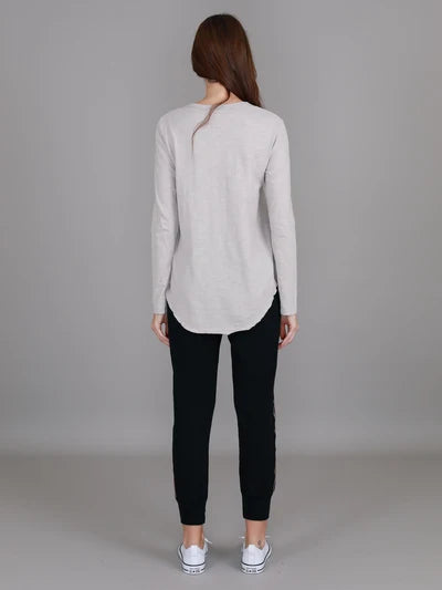 Angora Penola Long Sleeve T-Shirt featuring a crew neckline, relaxed full-length sleeves, straight silhouette and curved raw-edge hi-lo hem.