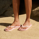 Pink Archies support thongs with up to 2.2cm orthotic support, designed for comfort and foot alignment, perfect for plantar fasciitis relief.