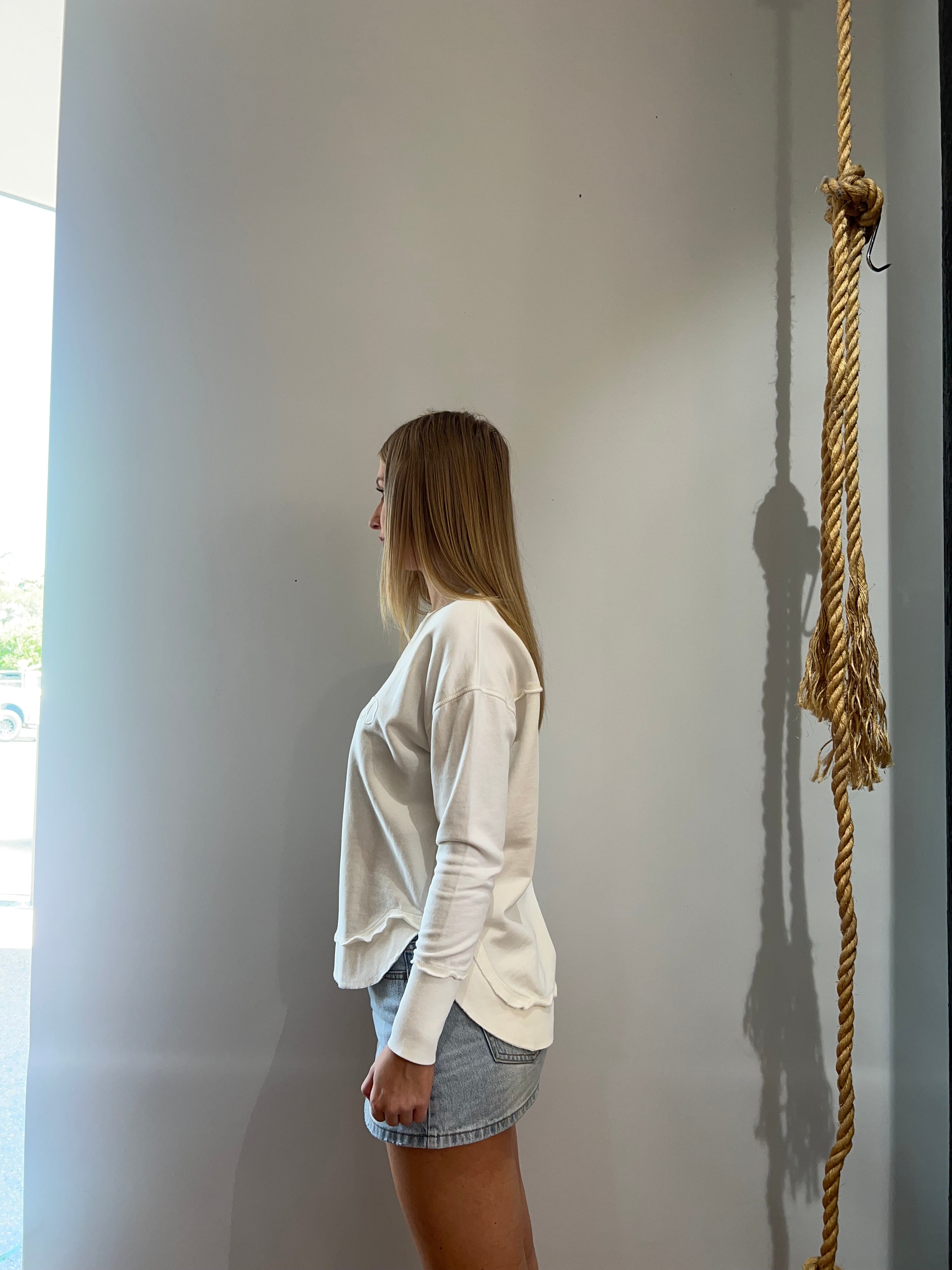 Foxwood Simplified Crew in Ecru featuring front chest embroidery, raw edge detailing, a curved hem and soft 100% cotton fabric.