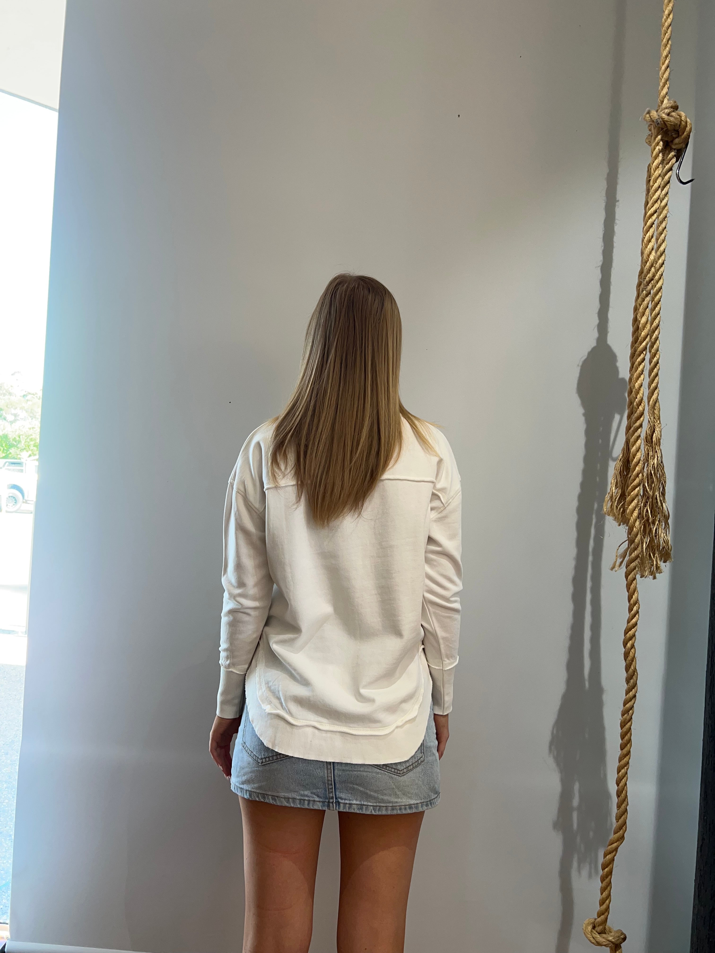 Foxwood Simplified Crew in Ecru featuring front chest embroidery, raw edge detailing, a curved hem and soft 100% cotton fabric.