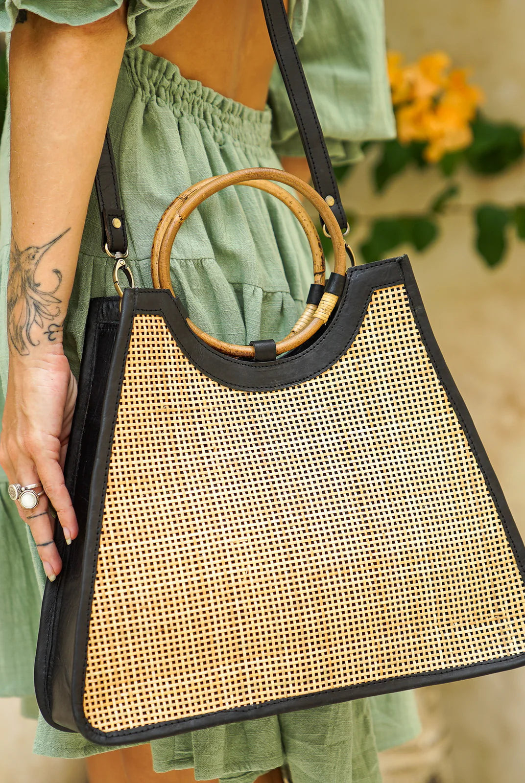 Singapore Bag in black featuring natural rattan weaving with genuine leather detailing in a structured summer handbag design.