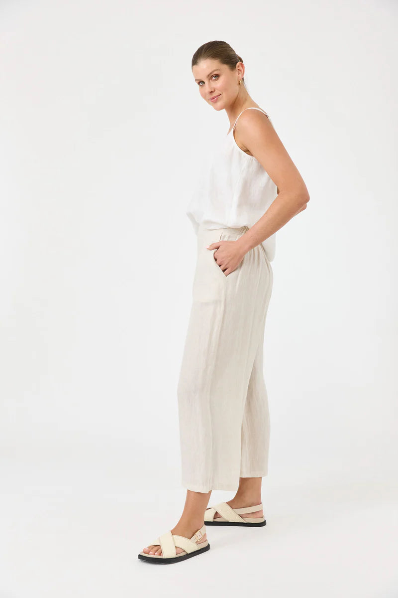 Studio Crop Pant in Tusk, made from breathable linen, featuring a wide-leg cropped fit, elasticated waistband, side pockets, and a relaxed, flowy silhouette.