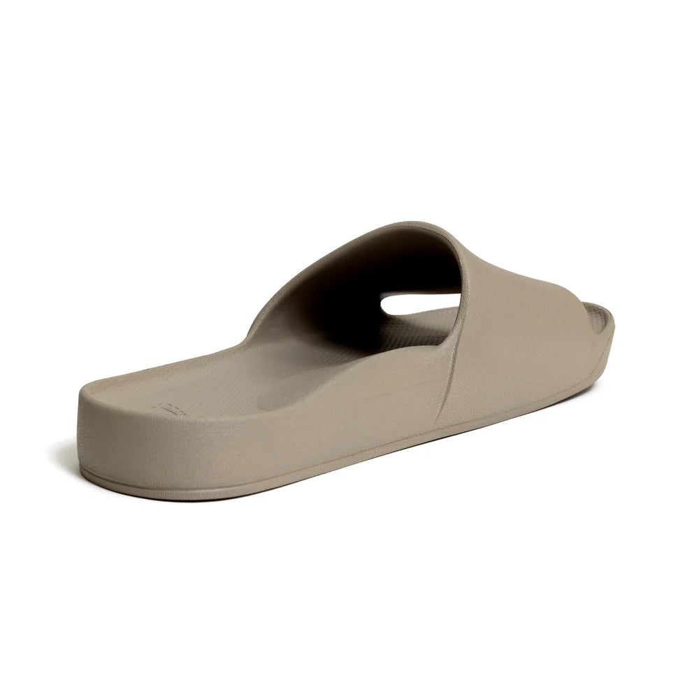 The Taupe Arch Support Slides by Archies are available at Rawspice Boutique.