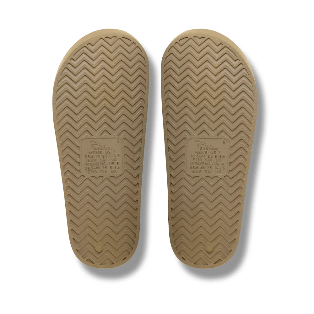 The Taupe Arch Support Slides by Archies are available at Rawspice Boutique.