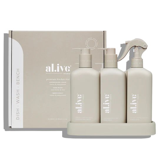 The Alive Kitchen Trio Set, featuring Dishwashing Liquid and Bench Spray in Lemon & Pomegranate scent, and Hand Wash in Watermelon & Lime scent, all neatly arranged in a sleek, custom tray. The white bottles with vibrant, fresh-colored labels are displayed on a clean countertop, exuding a refreshing and vibrant aesthetic with fruity, citrus-inspired fragrances.