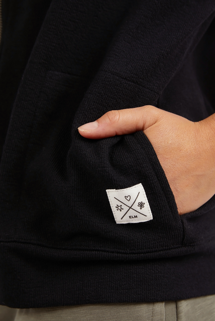 The Black Beachy Zip Hoodie by ELM is available at Rawspice Boutique.