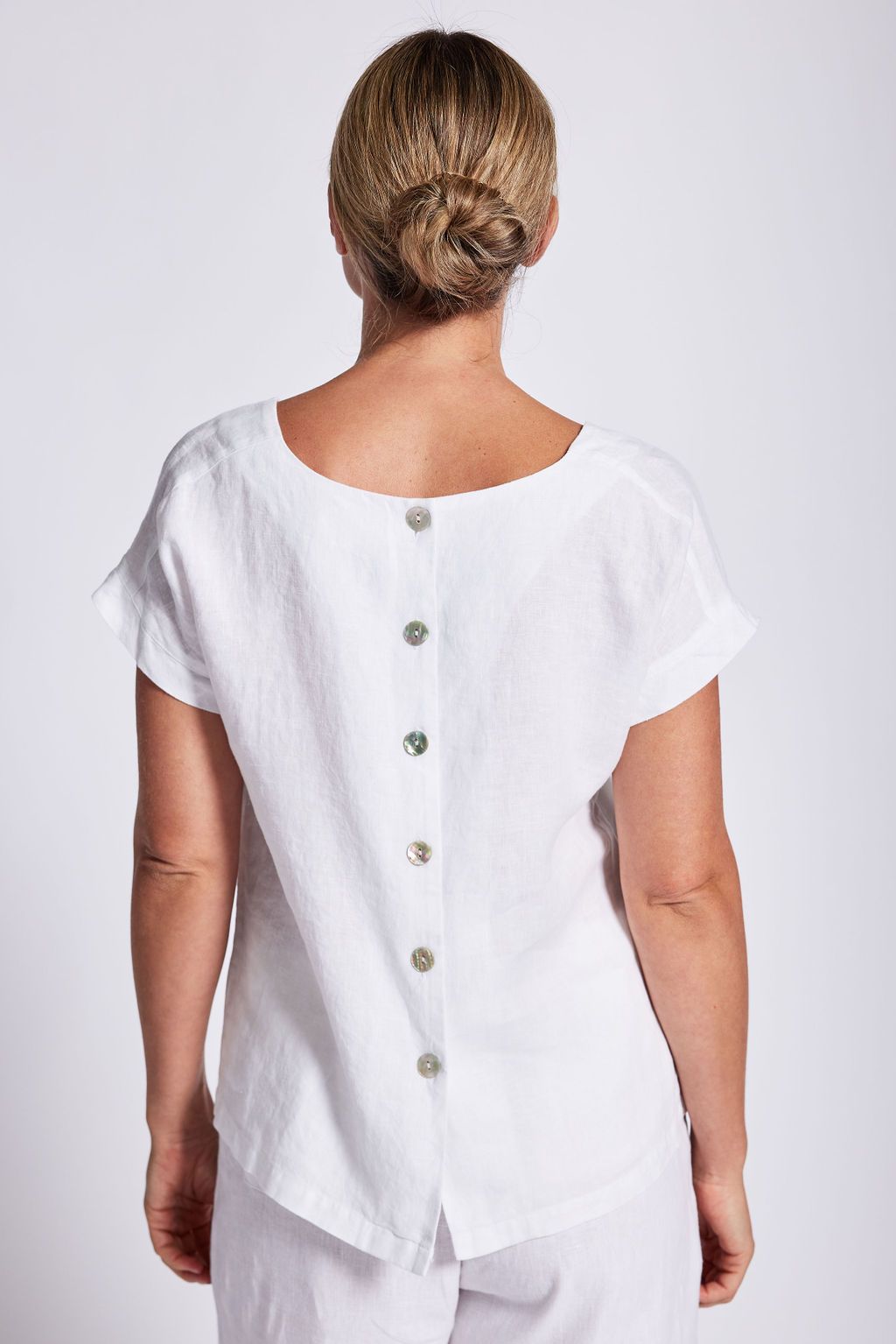 The White Cap Sleeve Button Back Top by See Saw is available at Rawspice Boutique.