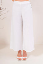 Palazzo linen pants featuring a relaxed wide-leg fit, high waist and shell button detailing down the side seam.